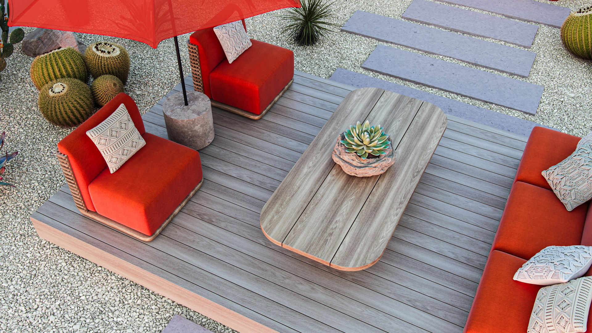 The image shows an above view of an outdoor patio. The floor is made of pebbles and rocks. A deck is set on top of the patio floor with an orange furniture set. There is a stone walkway leading to the deck and cacti.